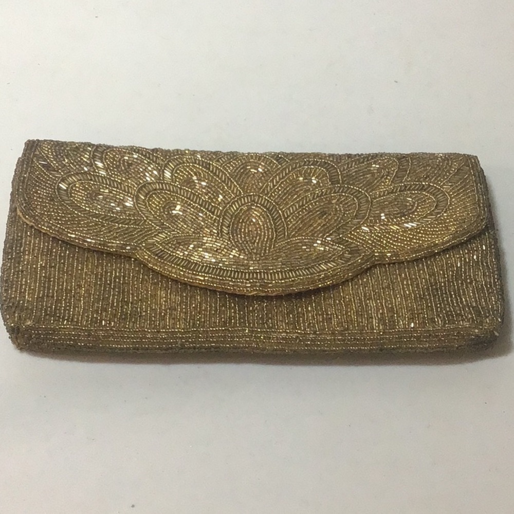 Sparkly gold sequined “Bechamel” brand clutch or cross body. Has metal strap.